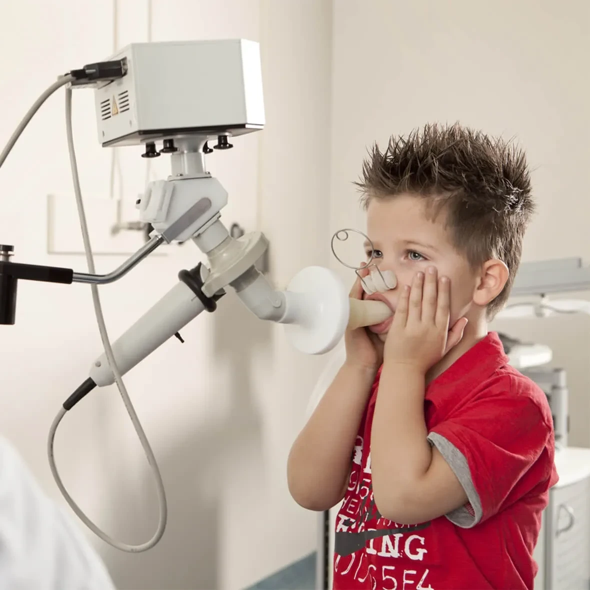 Child undergoing respiratory function testing for impulse oscillometry